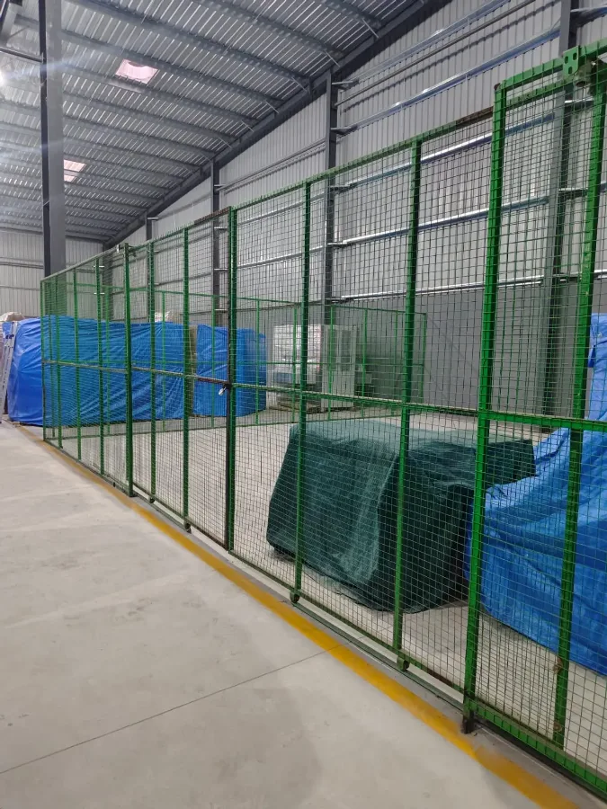 Real StowFlex secured wire-mesh storage cage with tarped seized assets