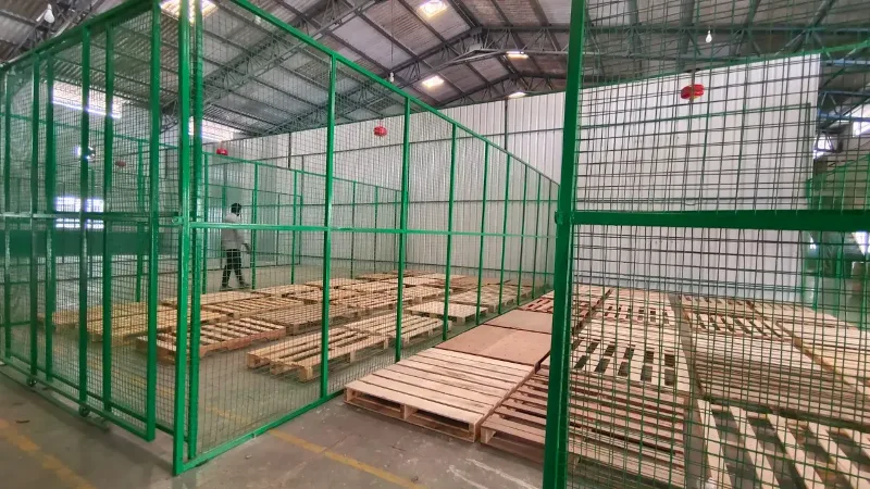 Real StowFlex secured storage cage with organized pallets, ready for tracked asset intake